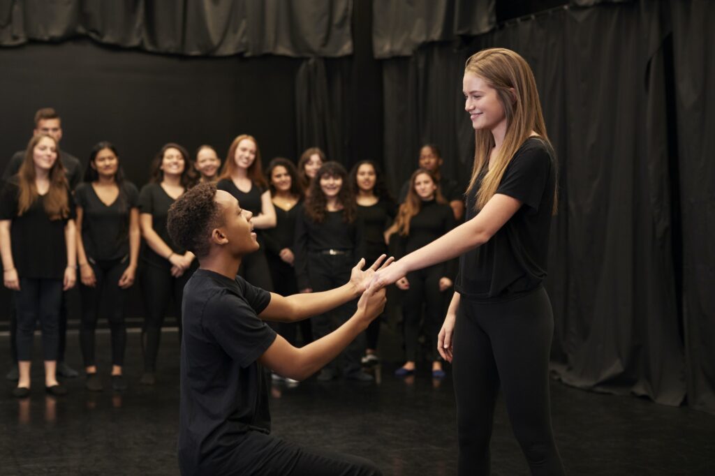 Male And Female Drama Students At Performing Arts School In Studio Improvisation Class